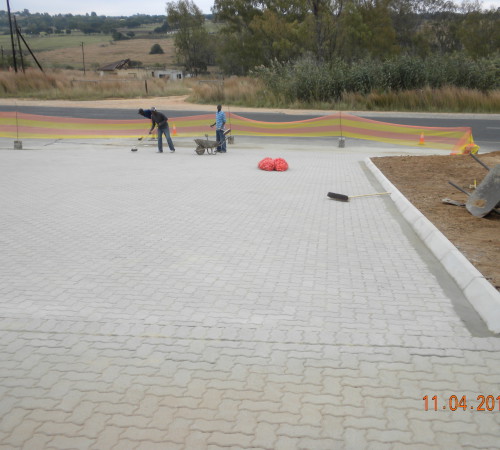 Paving in and finishing sweeping in final plaster sand and cement mix 