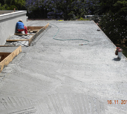 Concrete roof slab in, being floated and ready for screeding and waterproofing.