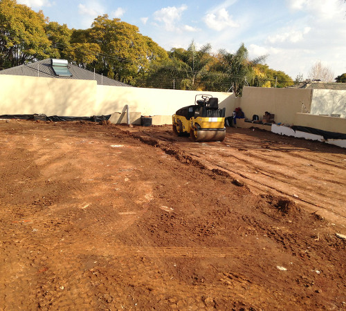 Compacted layers of blended rubble and fill material